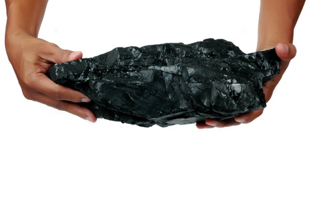 a big lump of coal is held with two hands isolated on white background