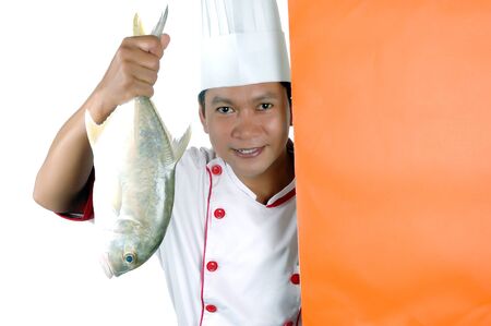 chef holding a big raw fish with orange blank space isolated on white backgroundの写真素材