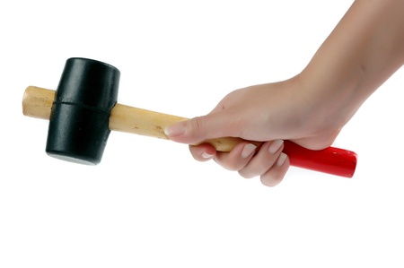 female hand holding a rubber-headed hammer isolated on white backgroundの写真素材