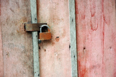dull wooden doors locked padlockの写真素材