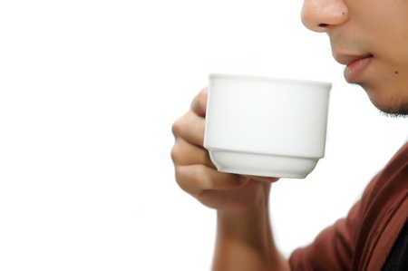 a man drinking coffee isolated on white backgroundの写真素材