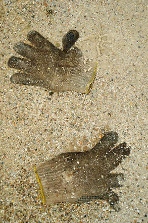 a pair of gloves worn embedded in the sand