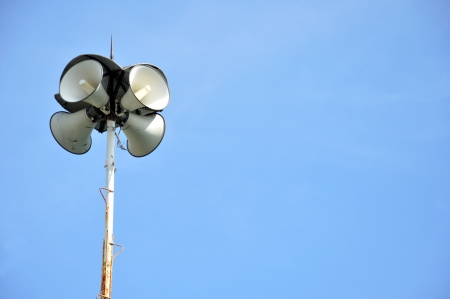 four funnel loudspeakers against blue skyの写真素材