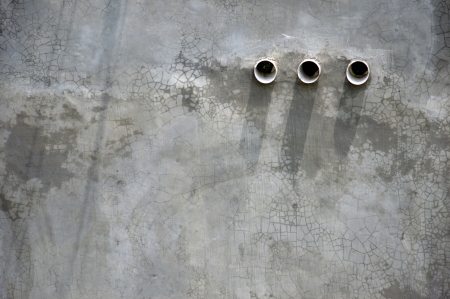 three air holes in the cement wallの写真素材