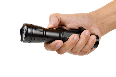 hand holding a black flashlight isolated on white backgroundの写真素材