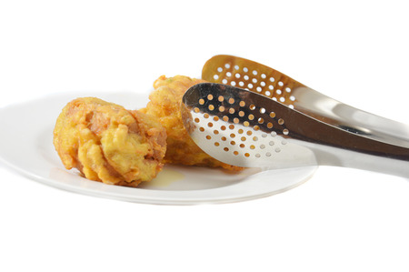 fried tofu with steel tongs  isolated on white background