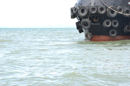 scrap tires as a shield on the tug boat の写真素材