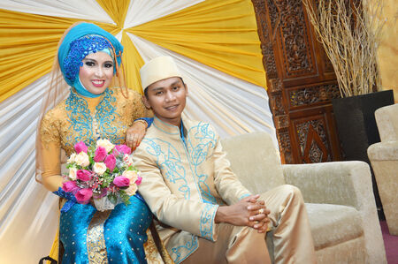 Indonesian bridal couples were dressed in traditional modern moslem bridal costumeの写真素材