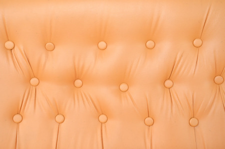 texture and pattern of orange leather seat upholstery