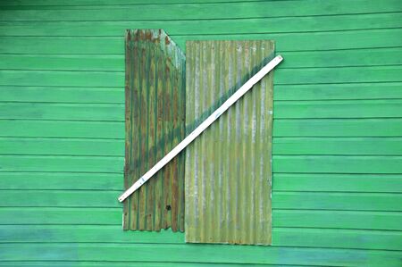 closed window on green wooden boardの写真素材