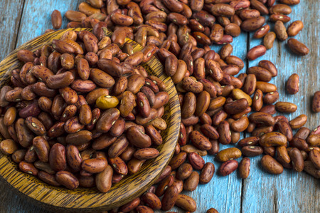 red beans with wooden bowl on the blue wooden table