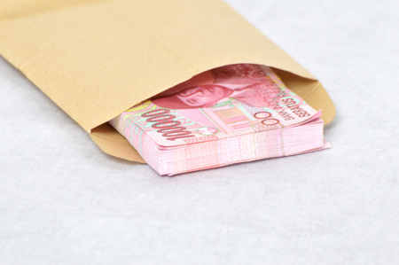 Indonesian paper money in a brown envelope