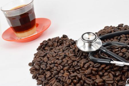 stethoscope with coffee beans on white backgroundの写真素材