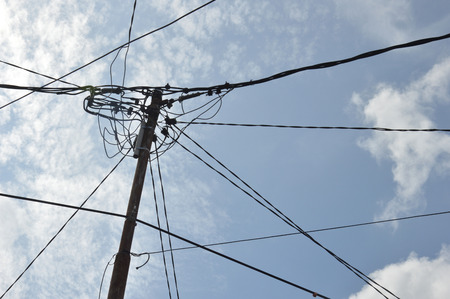 electricity poles against blue sky