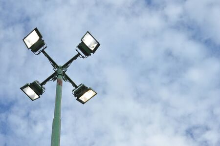 park light poles with white clouds and blue sky backgrounds