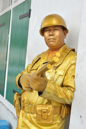 JAKARTA, INDONESIA - AUGUST, 20, 2016 :  action golden soldier dressed in Indonesia at Kota Tua or Old City in Jakarta, Indonesiaのeditorial素材