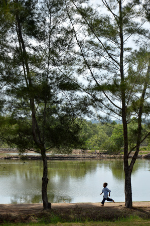 TARAKAN, INDONESIA - 30th MAY 2016 : Muslim boys running by the poolのeditorial素材