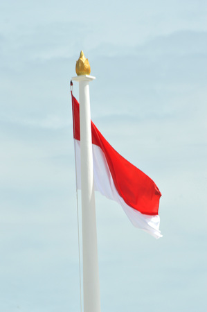 Indonesia's flag against blue skyの写真素材