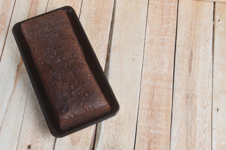 chocolate brownies on wooden table with raw materialsの写真素材