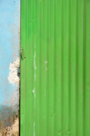 green zinc door with blue wallの写真素材