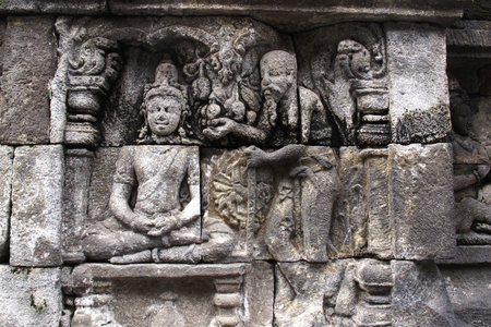 Bas-relief sculptures on wall at encased foot of Borobudur, Indonesiaのeditorial素材