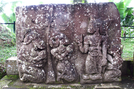 Bas-relief sculptures on wall at encased foot of Sukuh Temple, ancient historical heritage site in central Java  - Indonesiaのeditorial素材