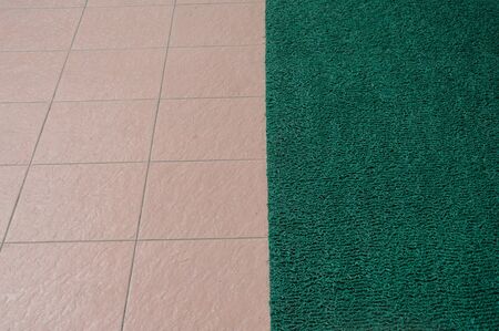 floor tiles surface with green matの写真素材