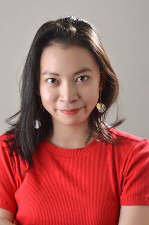 beautiful asian chinese girl, dressed in red casual with facial expression in a white bakground...