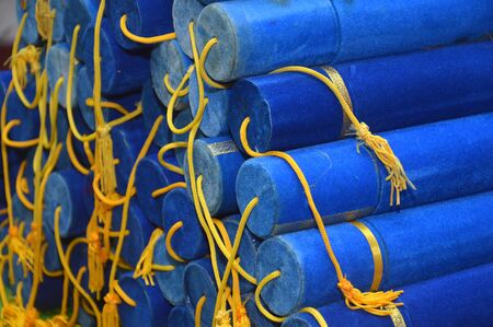 scholarly diplomas on the blue velvet cylindrical containerの写真素材