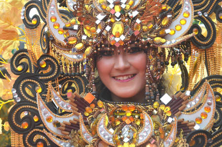 TARAKAN - INDONESIA, 25 July 2018 : Portrait of a beautiful Indonesian woman smiling wearing modified custom carnival clothes. APEKSI Cultural Parade Tarakan City in 2018のeditorial素材