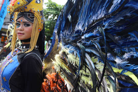 TARAKAN - INDONESIA, 25 July 2018 : Portrait of a beautiful Indonesian woman smiling wearing modified custom carnival clothes. APEKSI Cultural Parade Tarakan City in 2018のeditorial素材