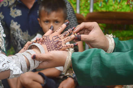 TARAKAN - INDONESIA, 16 MARCH 2019 : the Indonesian bridegroom attach the ring to the bride's finger