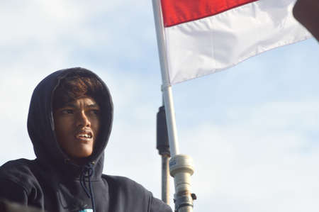 TARAKAN, INDONESIA. 21 december 2019 : portrait of Indonesian young people against the background of the red and white flagのeditorial素材