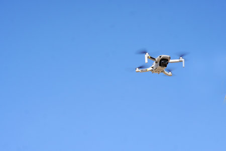 drone hovering in the blue sky air
