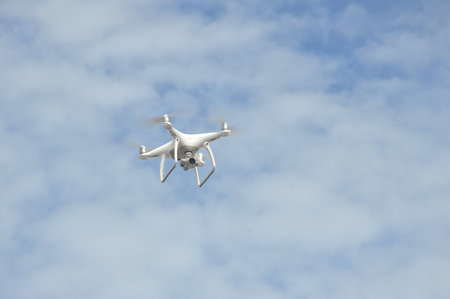 drone hovering in the blue sky air