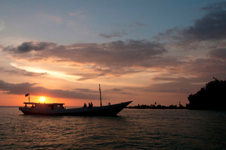 Enjoy a stunning ocean sunset cruise with friends. This tranquil scene evokes adventure, relaxation,...
