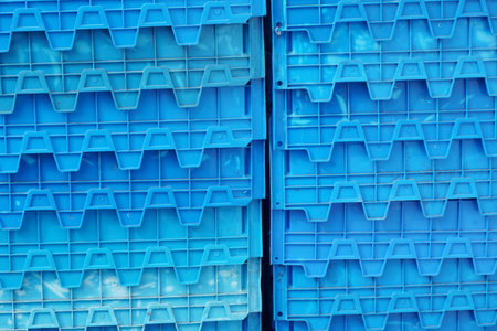 Organized stacks of sturdy blue plastic crates, perfect for industry, storage, or modern design...