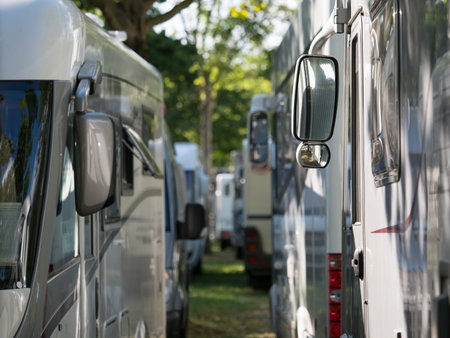 A row of motorhomes and recreational vehicles are closely parked one after the other at the Motorhome Show in Dusseldorf.Narrow depth of field for effectの写真素材