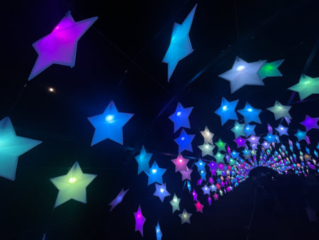 A colourful array of stars forming a tunnel walkway outdoors.Christmas decorationsの写真素材