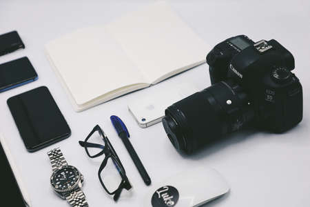modern photography equipment over white table background. Everyday accessories.のeditorial素材