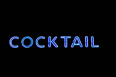 neon cocktail sign isolated on blackの写真素材