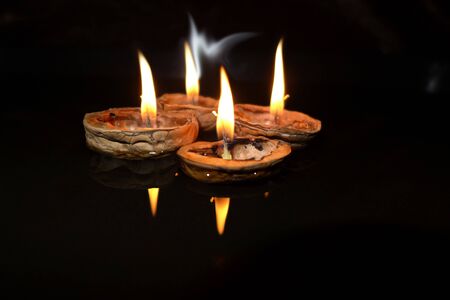 Burning candles on a floating shell, Christmas