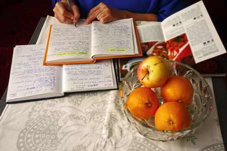 Woman writes recipes for Christmasの写真素材