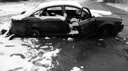 Abandoned and demolished car in the car parkの写真素材