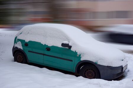 Snowy parked car in the parking lotの写真素材