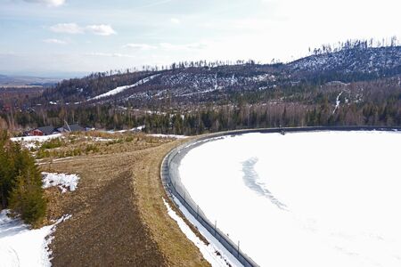 Frozen water reservoir in the mountainsの写真素材