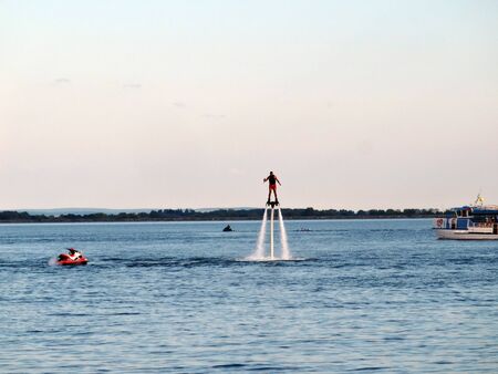 Sports activities on the lake in the recreation center in summer