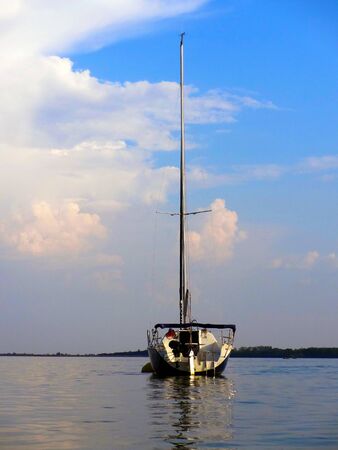 Yacht anchored off the coast of lake