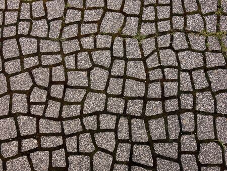 Walkway made of stone tiles in a clay base