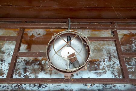 Damaged lamp on old abandoned building